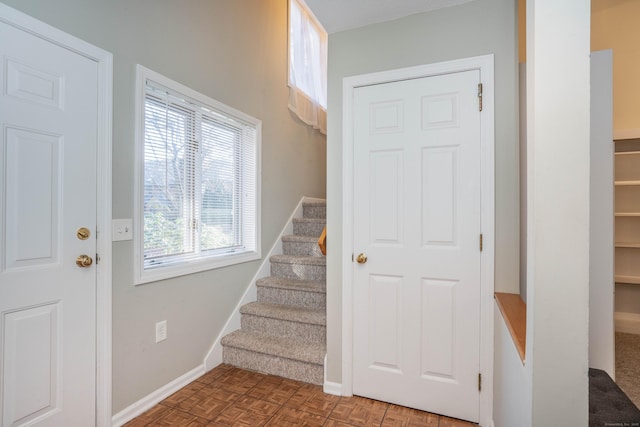 staircase featuring parquet floors