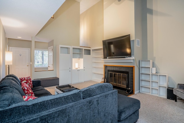 carpeted living room with a tile fireplace and lofted ceiling