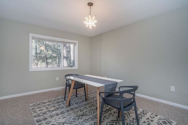 carpeted office space with an inviting chandelier