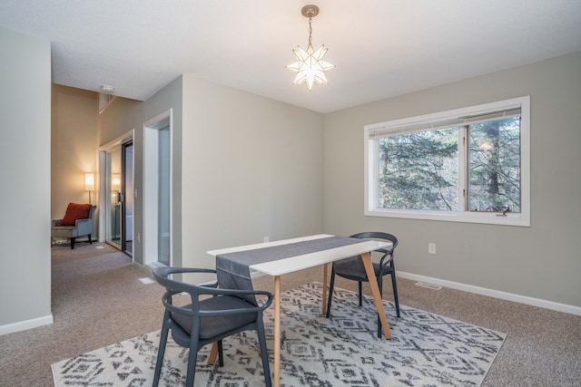 office with carpet floors and an inviting chandelier