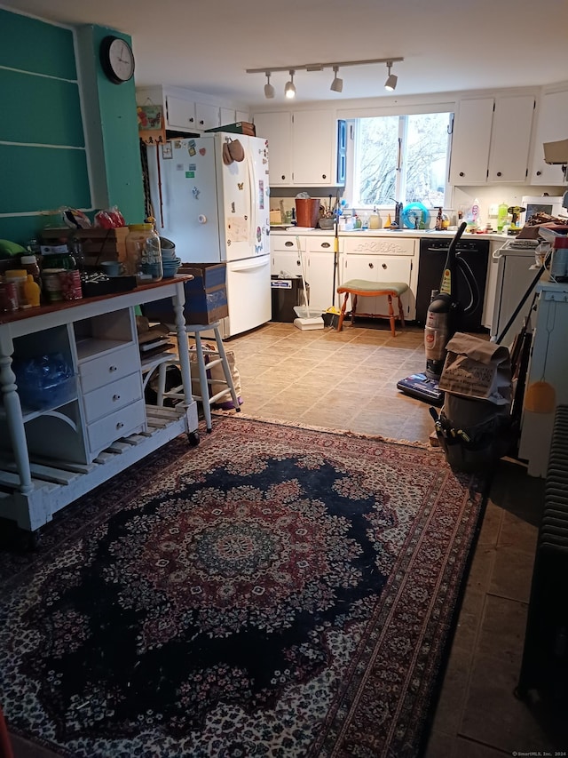 kitchen featuring light tile patterned floors, white cabinets, and white appliances