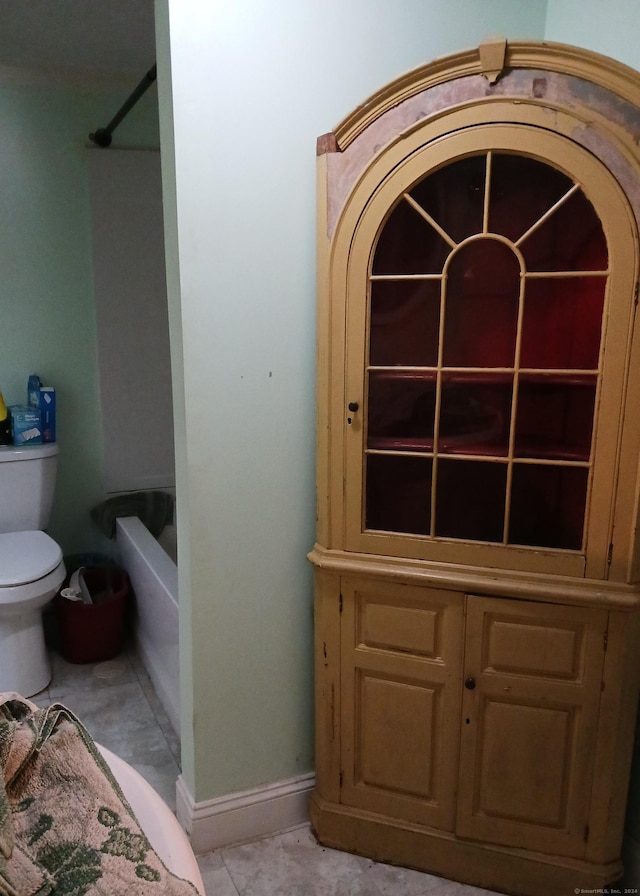 bathroom with tile patterned flooring and toilet