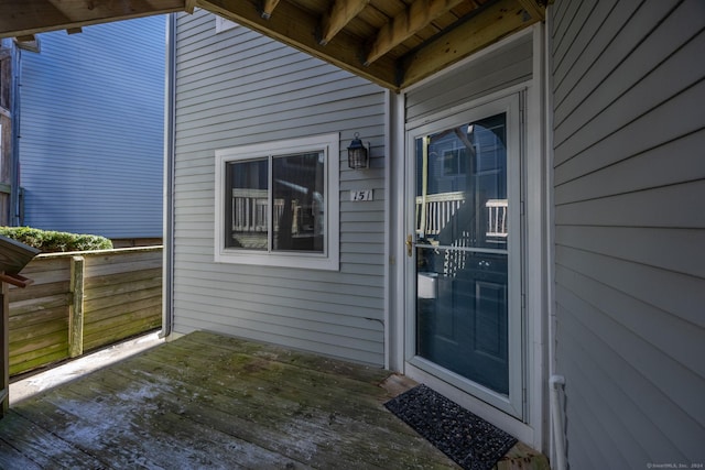 view of exterior entry featuring a deck