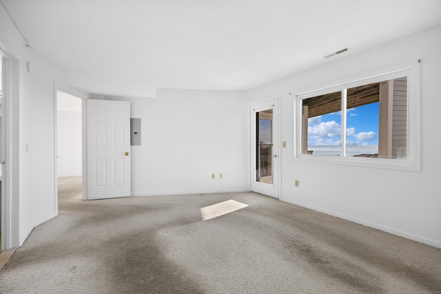 carpeted spare room with electric panel