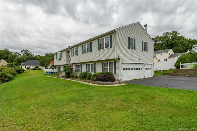 view of front of house featuring a garage and a front yard