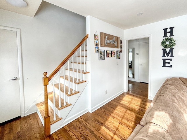 stairs with hardwood / wood-style flooring