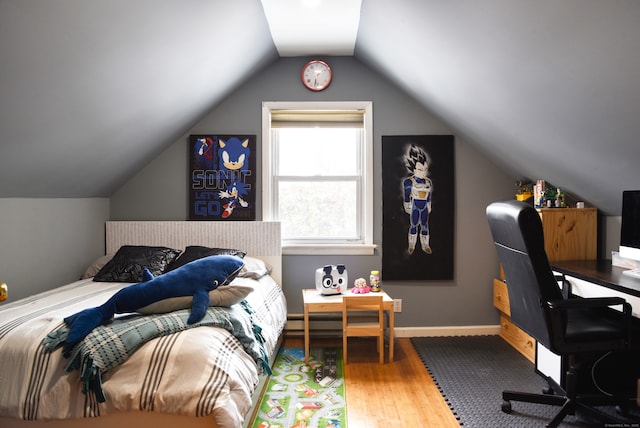 bedroom with wood-type flooring and vaulted ceiling