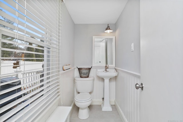 bathroom featuring sink, tile patterned floors, and toilet