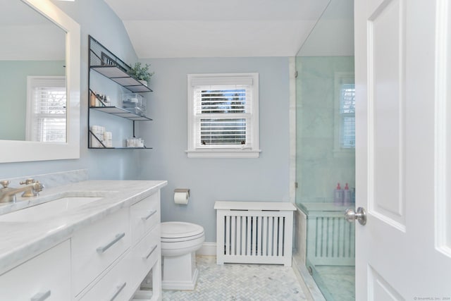 bathroom featuring radiator, a shower, lofted ceiling, vanity, and toilet