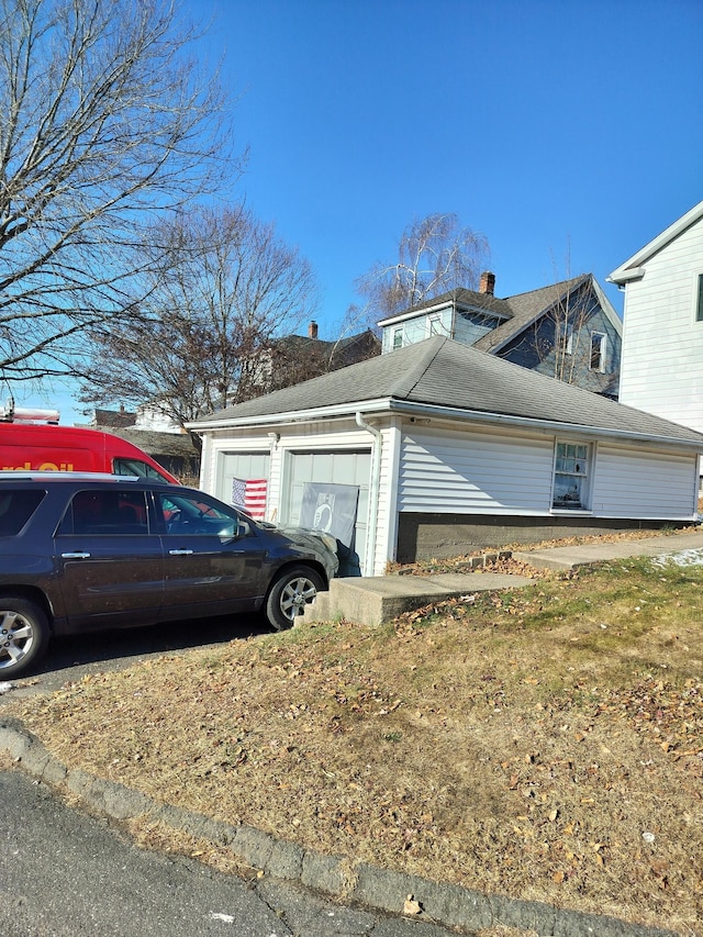 view of side of property with a garage