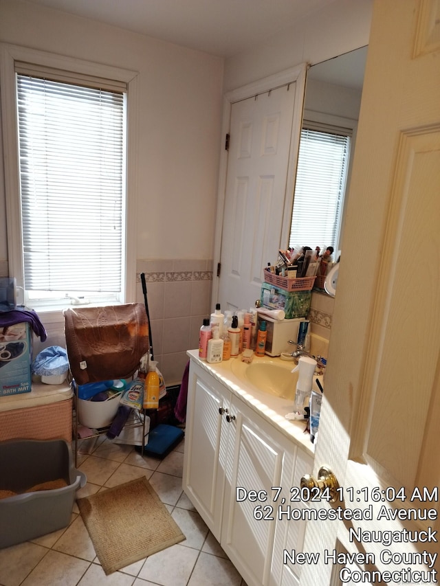 bathroom featuring tile patterned flooring, vanity, and a healthy amount of sunlight