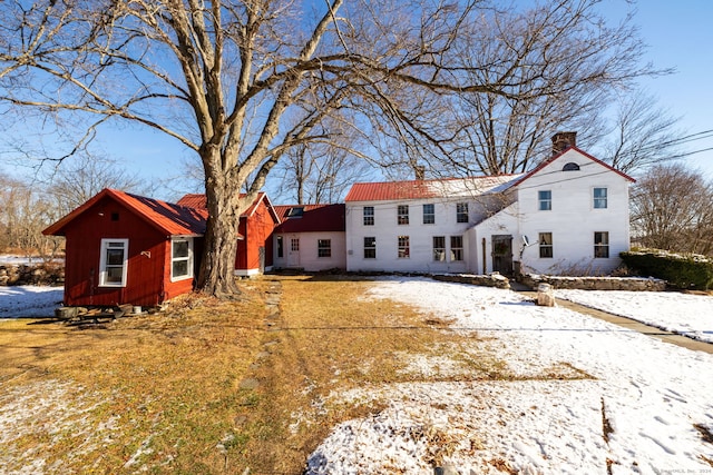 view of snow covered rear of property