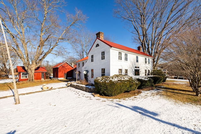 view of snow covered exterior featuring a storage shed