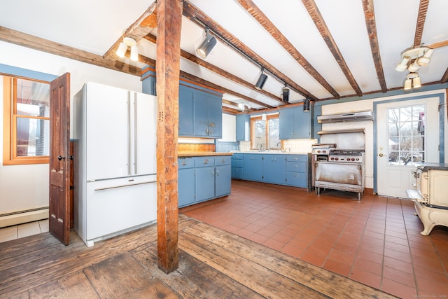 kitchen featuring dark tile patterned floors, beamed ceiling, blue cabinets, backsplash, and extractor fan