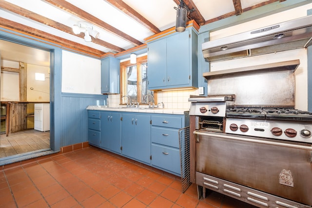 kitchen featuring beam ceiling, sink, tasteful backsplash, blue cabinets, and exhaust hood