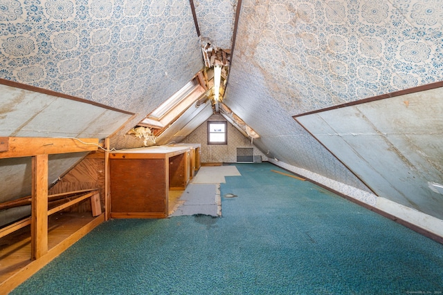 bonus room featuring carpet flooring and vaulted ceiling with skylight