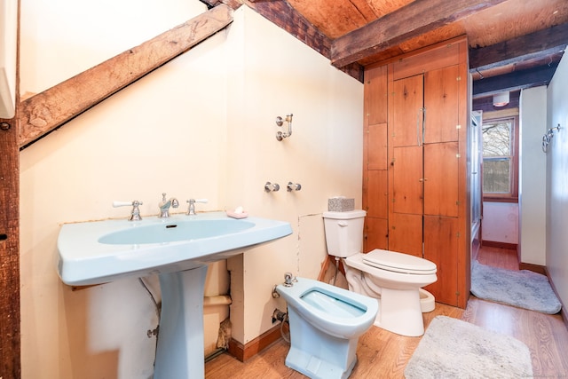 bathroom with beam ceiling, wooden ceiling, hardwood / wood-style floors, a bidet, and toilet