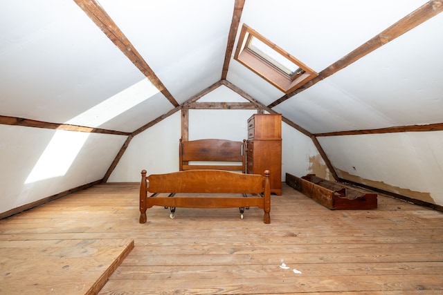 bonus room featuring vaulted ceiling with skylight and light hardwood / wood-style flooring