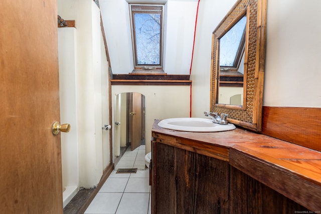 bathroom featuring tile patterned floors, vanity, and toilet