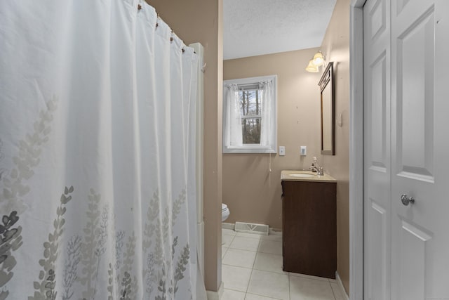 bathroom featuring a shower with curtain, tile patterned floors, a textured ceiling, toilet, and vanity