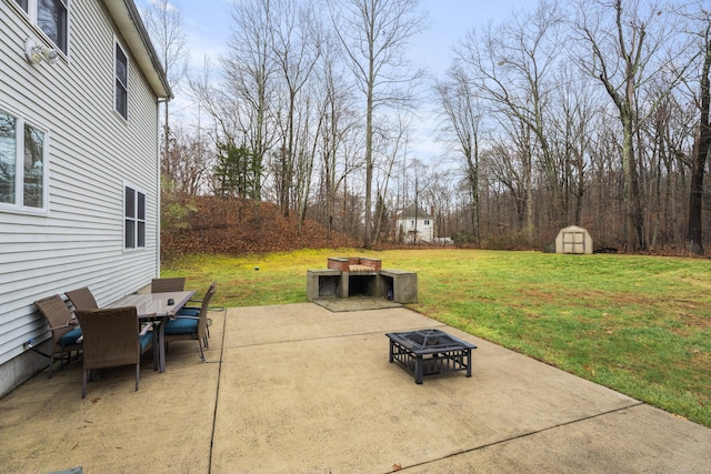 view of patio / terrace featuring a shed and an outdoor fire pit