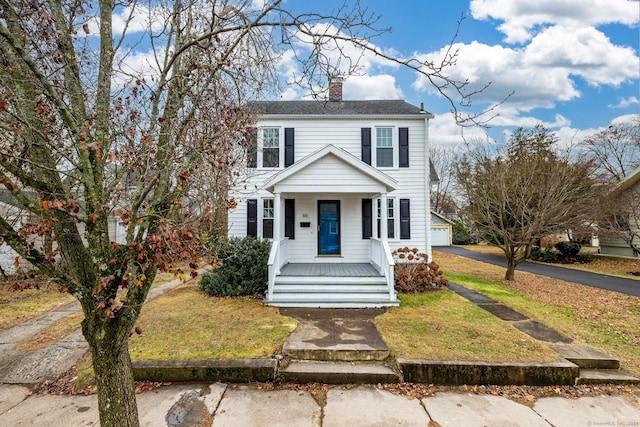 view of front facade with covered porch and a front yard