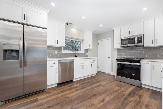 kitchen with white cabinets and appliances with stainless steel finishes