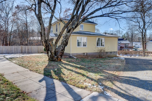 view of property exterior with a yard