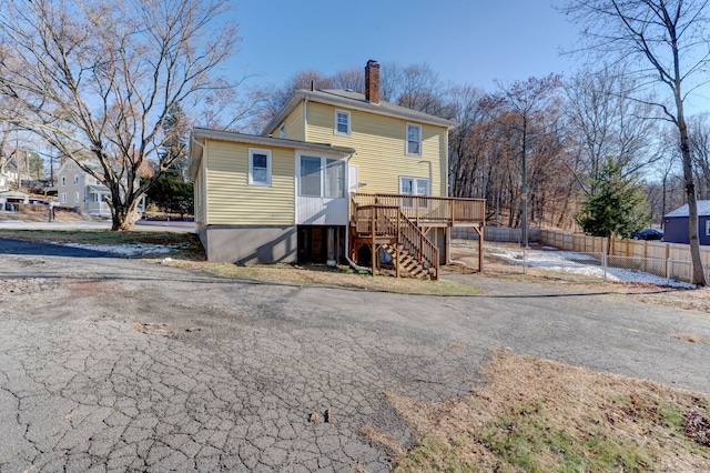 back of house with a wooden deck