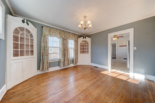 unfurnished dining area with light wood-type flooring, ornamental molding, and a chandelier