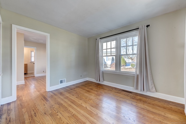 empty room with light hardwood / wood-style floors