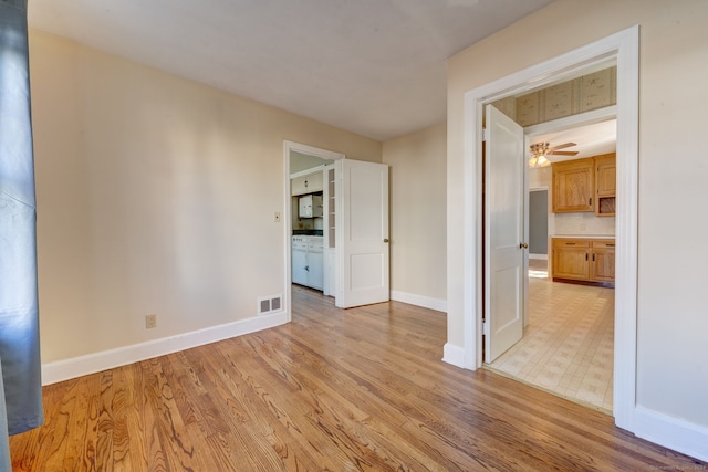 unfurnished room featuring ceiling fan and light hardwood / wood-style flooring