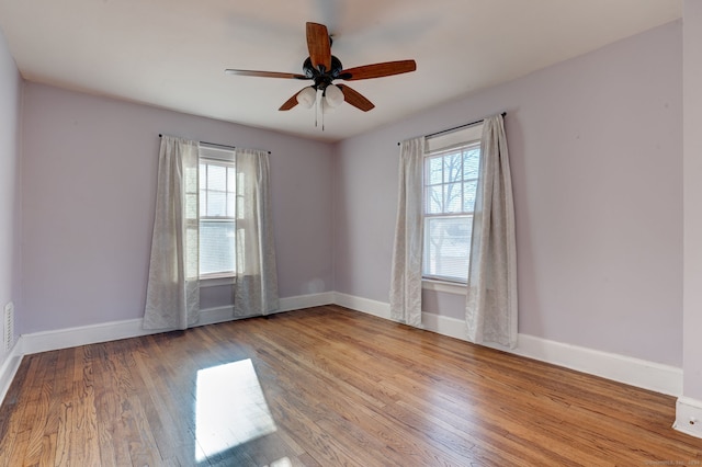 unfurnished room with light wood-type flooring, ceiling fan, and a healthy amount of sunlight