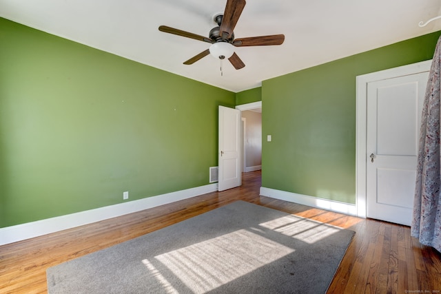 unfurnished bedroom with dark hardwood / wood-style floors and ceiling fan