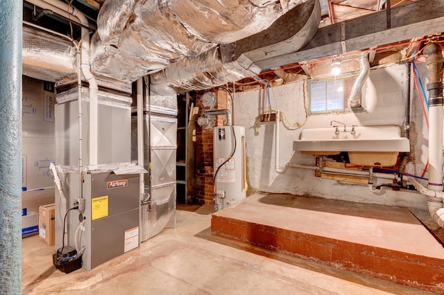 basement featuring heating unit, water heater, and sink