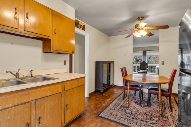 kitchen featuring ceiling fan and sink