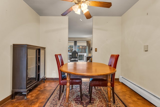 dining space featuring baseboard heating, ceiling fan, and dark hardwood / wood-style flooring