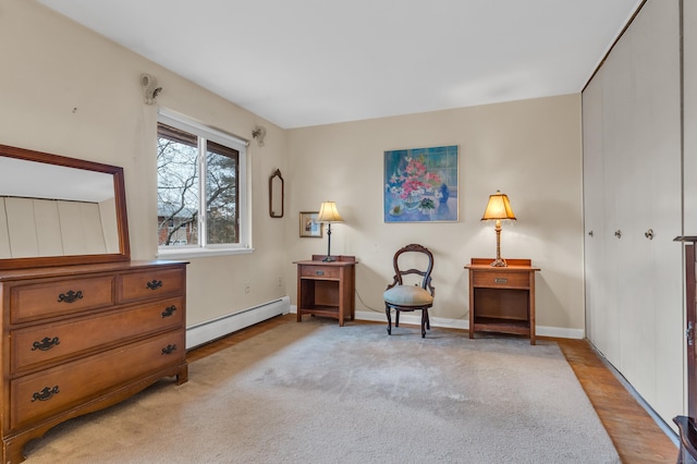 sitting room with light carpet and baseboard heating