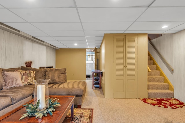 living room featuring light colored carpet and a drop ceiling