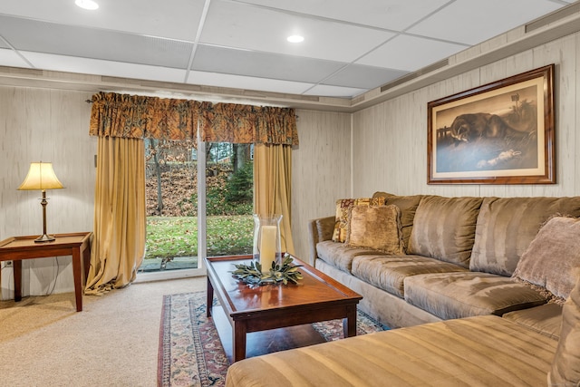 living room with a drop ceiling and carpet floors