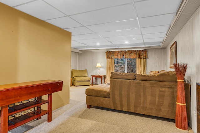 carpeted living room with a drop ceiling