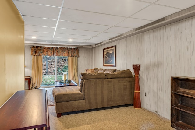 carpeted living room featuring a paneled ceiling