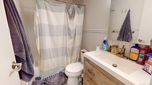 full bathroom with shower / bathtub combination with curtain, vanity, and toilet