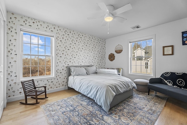 bedroom with ceiling fan and light wood-type flooring