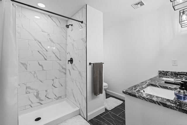 bathroom with vanity, curtained shower, and toilet