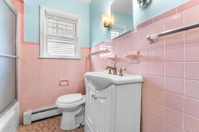 full bathroom with vanity, toilet, tile walls, and a baseboard heating unit