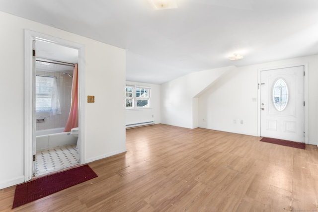 foyer entrance featuring light hardwood / wood-style flooring and baseboard heating