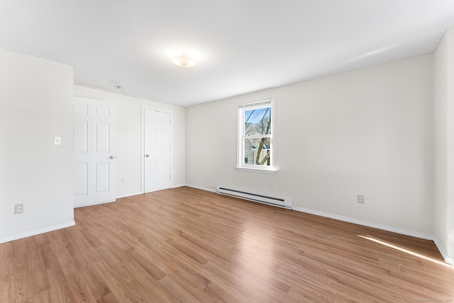 interior space featuring light wood-type flooring and baseboard heating