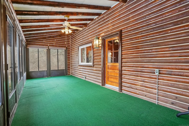 unfurnished sunroom featuring vaulted ceiling with beams and ceiling fan