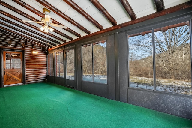 unfurnished sunroom featuring ceiling fan and vaulted ceiling with beams